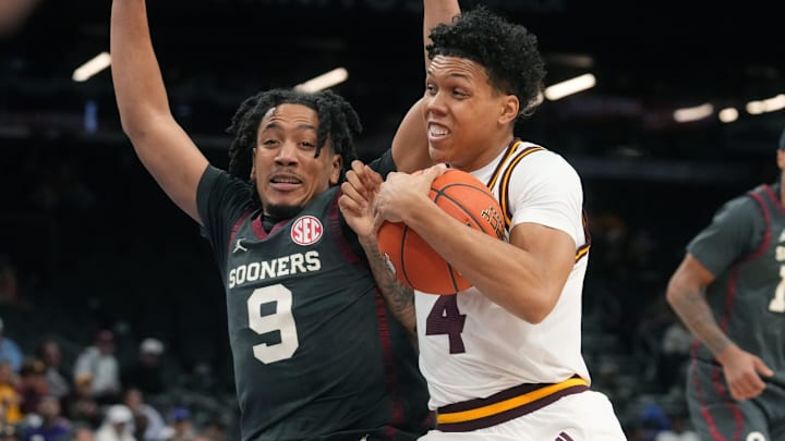ASU Sun Devils guard Bryce Ford (4) drives past Oklahoma Sooners guard Nijel Pack (9) at Mortgage Matchup Center on Dec. 6, 2025, in Phoenix, Arizona.