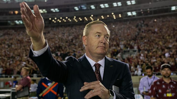 Florida State University Athletic Director Michael Alford stands on the sidelines as the war chant is played by the Marching Chiefs. Florida State University Athletic Director Michael Alford stands on the sidelines as the war chant is played by the Marching Chiefs.