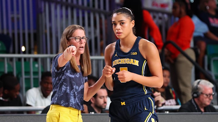 Nov 20, 2023; Paradise Island, BAHAMAS;  Michigan Wolverines head coach Kim Barnes Arico speaks with