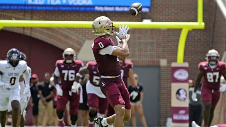 Sep 6, 2025; Tallahassee, Florida, USA; Florida State Seminoles wide receiver Duce Robinson (0) catches a touchdown during the first half against the East Texas A&M at Doak S. Campbell Stadium. Mandatory Credit: Melina Myers-Imagn Images