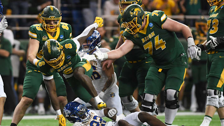 North Dakota State Bison running back Barika Kpeenu (8) trips over South Dakota State Jackrabbits cornerback Colby Humphrey (22) on Saturday, Dec. 21, 2024, at Fargodome in Fargo, Nouth Dakota.