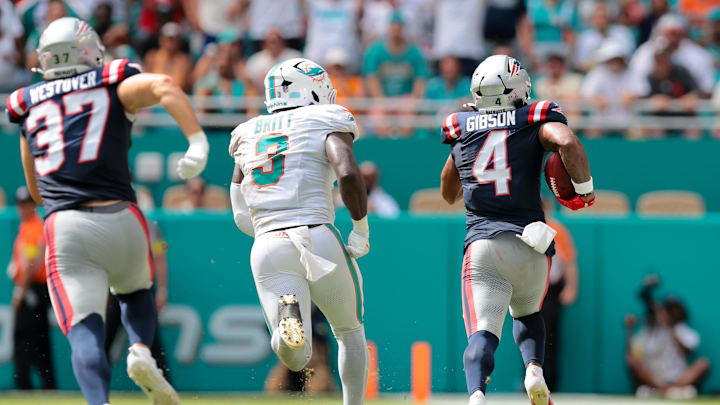 Sep 14, 2025; Miami Gardens, Florida, USA; New England Patriots running back Antonio Gibson (4) carries the football for a kickoff return against the Miami Dolphins during the fourth quarter at Hard Rock Stadium. Mandatory Credit: Sam Navarro-Imagn Images