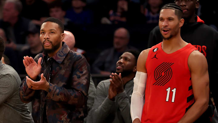 Nov 25, 2022; New York, New York, USA; Portland Trail Blazers injured guard Damian Lillard (left) and guard Josh Hart (11) react during overtime against the New York Knicks at Madison Square Garden. Mandatory Credit: Brad Penner-Imagn Images
