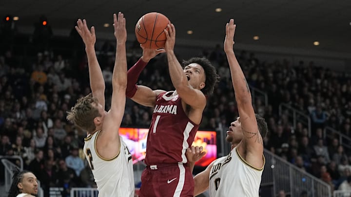 Dec 9, 2023; Toronto, Ontario, CAN; Alabama Crimson Tide guard Mark Sears (1) makes a basket against Purdue Boilermakers forward Mason Gillis (0) and guard Fletcher Loyer (2) during the first half at Coca-Cola Coliseum. Mandatory Credit: John E. Sokolowski-Imagn Images