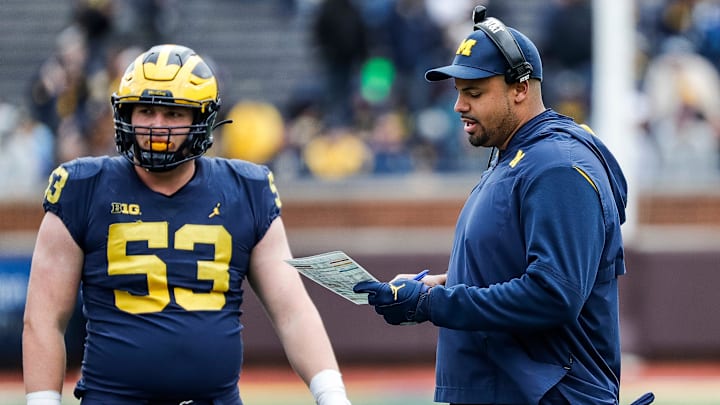 Michigan offensive line coach Grant Newsome talks to Blue Team players during the second half of the spring game at Michigan Stadium in Ann Arbor on Saturday, April 20, 2024.