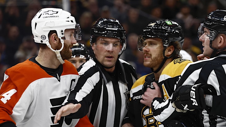 Dec 7, 2024; Boston, Massachusetts, USA; The linesman gets between Philadelphia Flyers center Sean Couturier (14) and Boston Bruins right wing David Pastrnak (88) during the second period at TD Garden. Mandatory Credit: Winslow Townson-Imagn Images