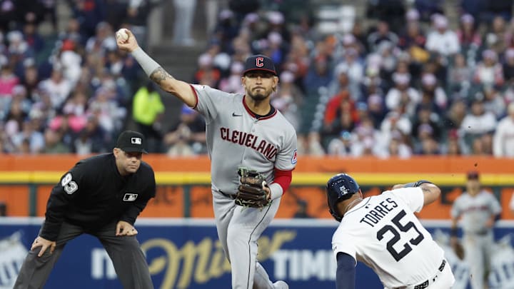The Guardians' Gabriel Arias throws to first after tagging the Tigers' Gleyber Torres.