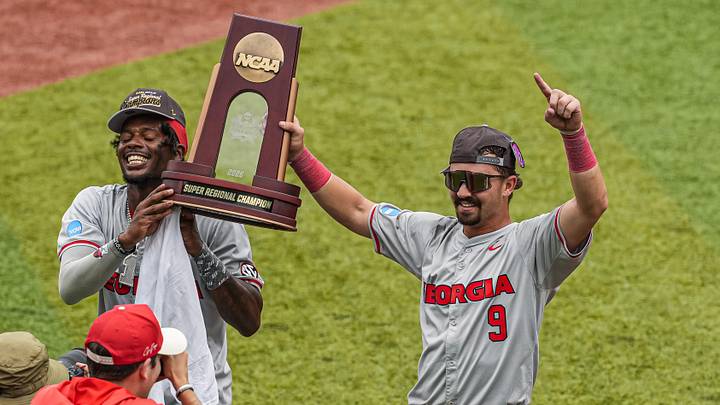 Jun 7, 2026; Athens, GA, USA; Georgia Bulldogs infielders Tre Phelps (1) and Kolby Branch (9) carry the Super Regional championship trophy after Georgia defeated the Mississippi State Bulldogs at Foley Field. Mandatory Credit: Dale Zanine-Imagn Images Jun 7, 2026; Athens, GA, USA; Georgia Bulldogs infielders Tre Phelps (1) and Kolby Branch (9) carry the Super Regional championship trophy after Georgia defeated the Mississippi State Bulldogs at Foley Field. Mandatory Credit: Dale Zanine-Imagn Images