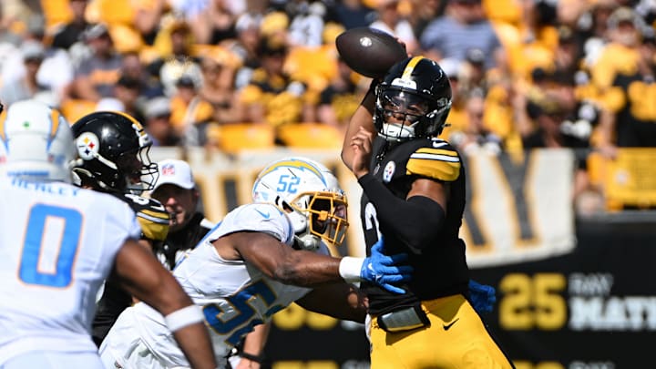Sep 22, 2024; Pittsburgh, Pennsylvania, USA; Pittsburgh Steelers quarterback Justin Fields (2) throws a pass while under pressure from Los Angeles Chargers linebacker Khalil Mack (52) during the second quarter at Acrisure Stadium. Mandatory Credit: Barry Reeger-Imagn Images