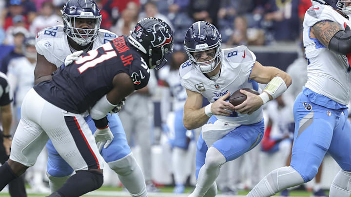Nov 24, 2024; Houston, Texas, USA; Tennessee Titans quarterback Will Levis (8) runs with the ball as Houston Texans defensive end Will Anderson Jr. (51) attempts to make a tackle during the first quarter at NRG Stadium.