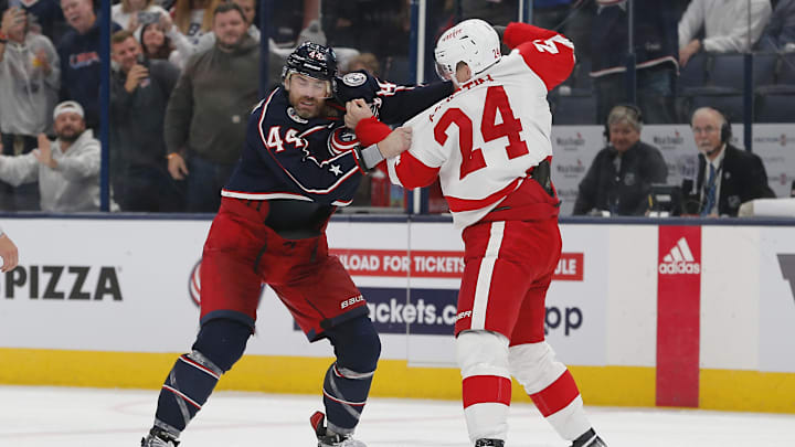 Columbus Blue Jackets defenseman Erik Gudbranson (44) and Detroit Red Wings forward Klim Kostin drop the gloves.