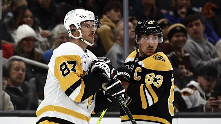 Nov 29, 2024; Boston, Massachusetts, USA; Captains, Pittsburgh Penguins center Sidney Crosby (87) and Boston Bruins left wing Brad Marchand (63) look back towards their benches as the referees sort out penalties against each team during the first period at TD Garden. Mandatory Credit: Winslow Townson-Imagn Images