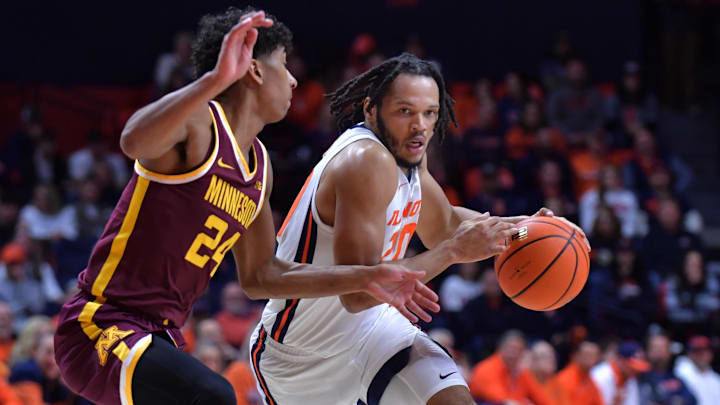 Feb 28, 2024; Champaign, Illinois, USA; Illinois Fighting Illini forward Ty Rodgers (20) drives the ball against Minnesota Golden Gophers guard Cam Christie (24) during the first half at State Farm Center. Mandatory Credit: Ron Johnson-Imagn Images