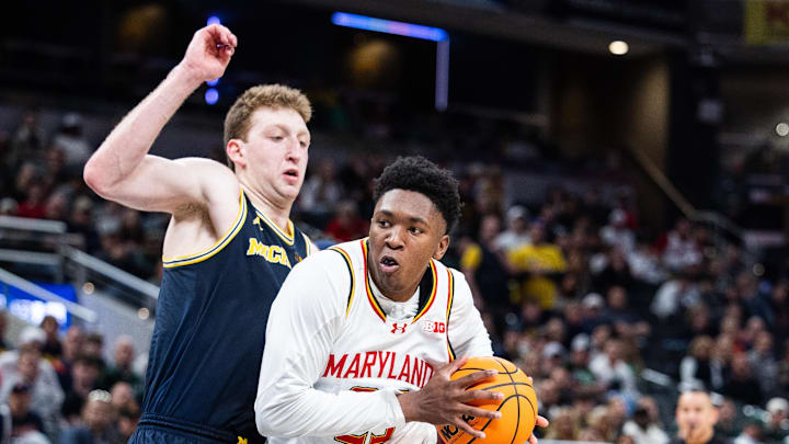 Mar 15, 2025; Indianapolis, IN, USA; Maryland Terrapins center Derik Queen (25) dribbles the ball while Michigan Wolverines center Danny Wolf (1) defends in the second half at Gainbridge Fieldhouse. Mandatory Credit: Trevor Ruszkowski-Imagn Images