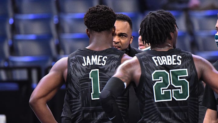 Feb 24, 2021; Memphis, Tennessee, USA; Tulane Green Wave head coach Ron Hunter talks with Tulane Green Wave guard Sion James (1) during the second half  at FedExForum.