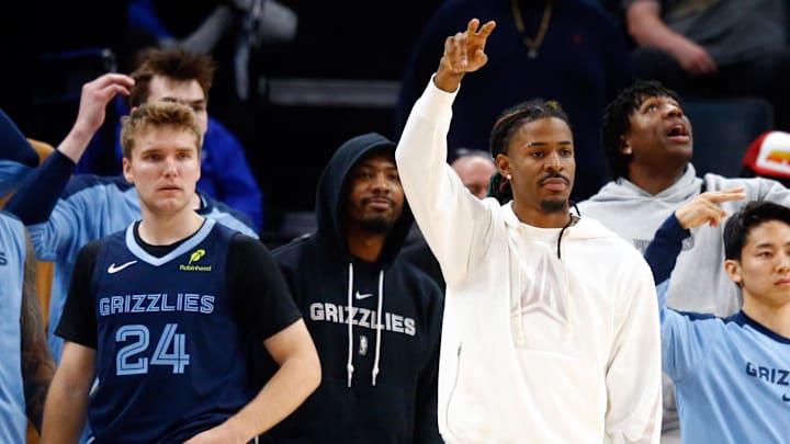 Nov 20, 2024; Memphis, Tennessee, USA; Memphis Grizzlies guards Cam Spencer (24), Marcus Smart (36) and Ja Morant (12) on the bench during the second half against the Philadelphia 76ers at FedExForum. Nov 20, 2024; Memphis, Tennessee, USA; Memphis Grizzlies guards Cam Spencer (24), Marcus Smart (36) and Ja Morant (12) on the bench during the second half against the Philadelphia 76ers at FedExForum.