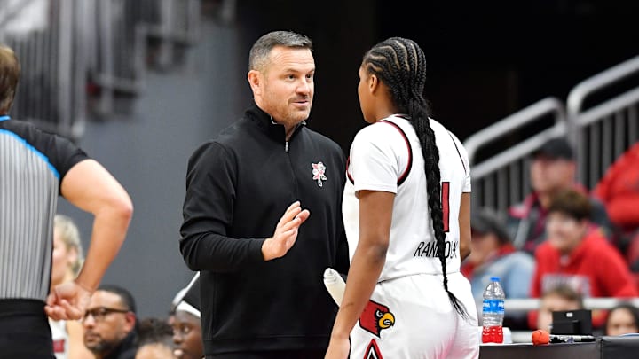Louisville head coach Jeff Walz talks to forward Mackenly Randolph (4) during the first half of an NCAA college basketball game against NC State, Sunday, Dec. 15 2024 in Louisville Ky.