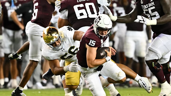 Aug 31, 2024; College Station, Texas, USA; Notre Dame Fighting Irish defensive lineman Howard Cross III (56) tackles Texas A&M Aggies quarterback Conner Weigman (15) at Kyle Field. Mandatory Credit: Maria Lysaker-USA TODAY Sports