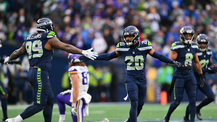 Dec 22, 2024; Seattle, Washington, USA; Seattle Seahawks defensive end Leonard Williams (99) and safety Julian Love (20) celebrate after a defensive stop against the Minnesota Vikings during the second half at Lumen Field. | | 