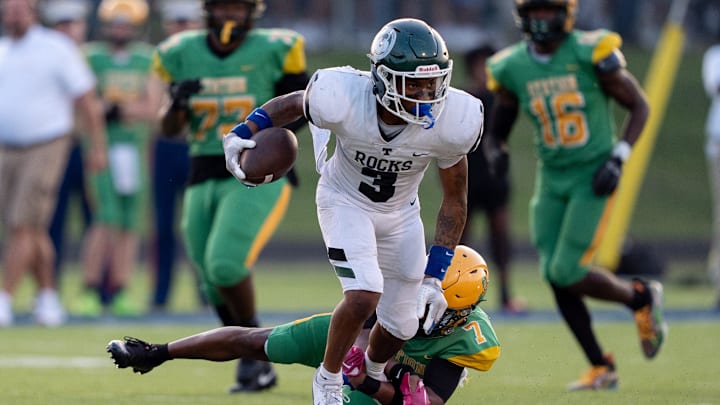 Bryan Station's Jordan Haskins (3) attempts to free himself from Bryan Station's Kaleb Bailey (7) during their game on Friday, Aug. 23, 2024 at Bryan Station High School in Lexington, Ky.