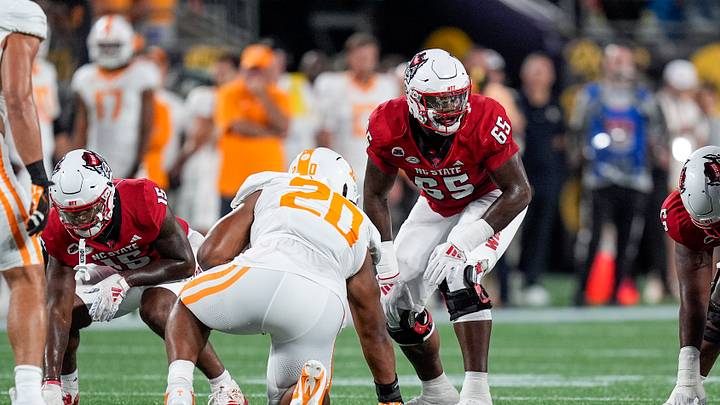 Sep 7, 2024; Charlotte, North Carolina, USA; North Carolina State Wolfpack offensive tackle Jacarrius Peak (65) lines up against Tennessee Volunteers defensive lineman Bryson Eason (20) during the first quarter at the Dukes Mayo Classic at Bank of America Stadium. Mandatory Credit: Jim Dedmon-Imagn Images Sep 7, 2024; Charlotte, North Carolina, USA; North Carolina State Wolfpack offensive tackle Jacarrius Peak (65) lines up against Tennessee Volunteers defensive lineman Bryson Eason (20) during the first quarter at the Dukes Mayo Classic at Bank of America Stadium. Mandatory Credit: Jim Dedmon-Imagn Images
