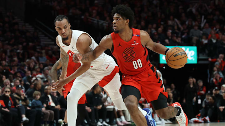 Mar 16, 2025; Portland, Oregon, USA; Portland Trail Blazers guard Scoot Henderson (00) dribbles the ball past Toronto Raptors guard A.J. Lawson (0) in the second half at Moda Center. Mandatory Credit: Jaime Valdez-Imagn Images Mar 16, 2025; Portland, Oregon, USA; Portland Trail Blazers guard Scoot Henderson (00) dribbles the ball past Toronto Raptors guard A.J. Lawson (0) in the second half at Moda Center. Mandatory Credit: Jaime Valdez-Imagn Images