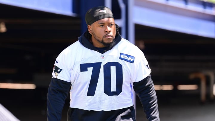Jun 10, 2024; Foxborough, MA, USA; New England Patriots offensive tackle Caedan Wallace (70) walks to the practice fields for minicamp at Gillette Stadium. Mandatory Credit: Eric Canha-USA TODAY Sports