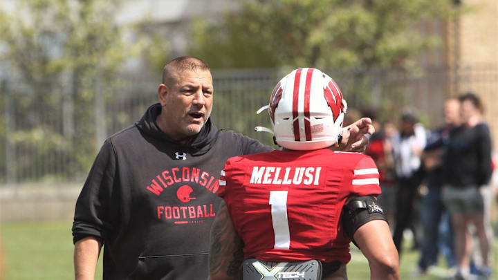 Wisconsin offensive coordinator Phil Longo chats with running back Chez Mellusi before the team's intrasquad scrimmage on the field north of Camp Randall Stadium in Madison, Wisconsin on Saturday April 27, 2024.