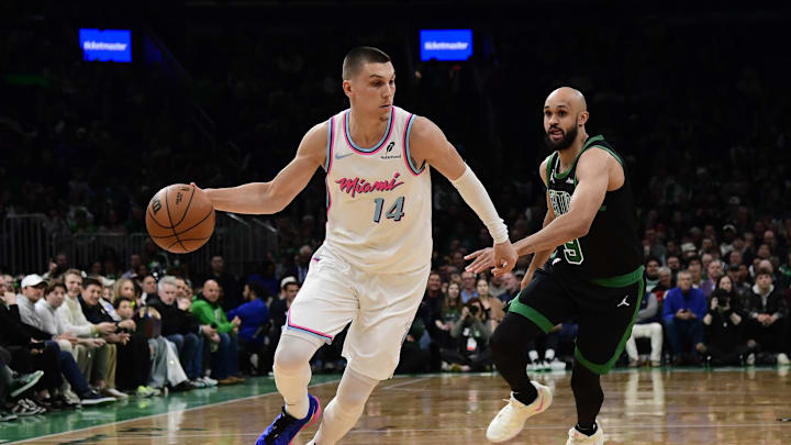 Apr 2, 2025; Boston, Massachusetts, USA; Miami Heat guard Tyler Herro (14) controls the ball while Boston Celtics guard Derrick White (9) defends during the first half at TD Garden. Mandatory Credit: Bob DeChiara-Imagn Images
