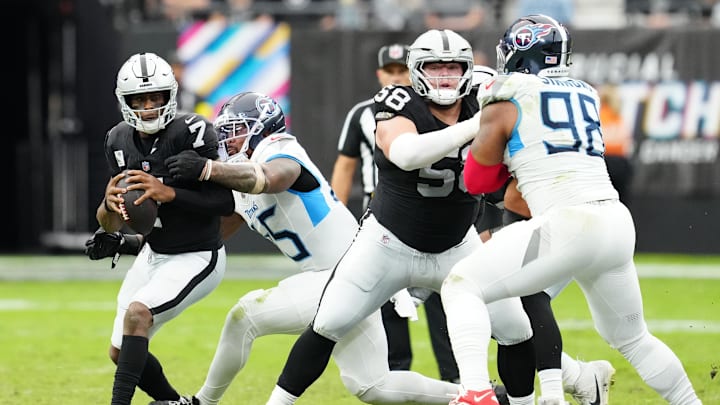 Oct 12, 2025; Paradise, Nevada, USA; Las Vegas Raiders quarterback Geno Smith (7) is sacked by Tennessee Titans linebacker Dre'Mont Jones (45) during the second half at Allegiant Stadium. Mandatory Credit: Stephen R. Sylvanie-Imagn Images