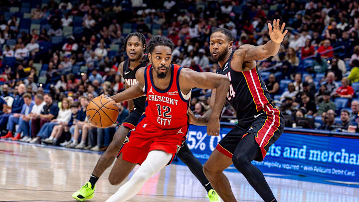 Apr 11, 2025; New Orleans, Louisiana, USA;  Miami Heat guard Dru Smith (12) dribbles against Miami Heat forward Haywood Highsmith (24) during the second half at Smoothie King Center. Mandatory Credit: Stephen Lew-Imagn Images