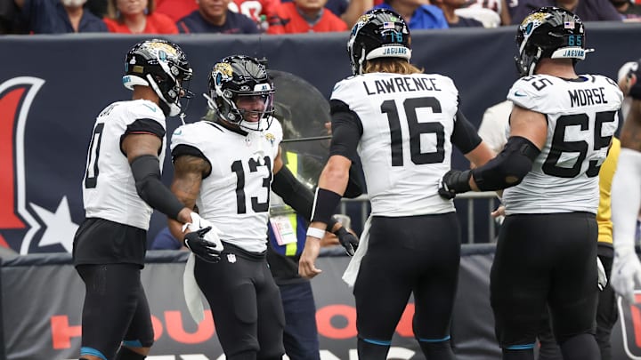 Sep 29, 2024; Houston, Texas, USA; Jacksonville Jaguars quarterback Trevor Lawrence (16) celebrates wide receiver Christian Kirk (13) touchdown against the Houston Texans in the second half at NRG Stadium. Mandatory Credit: Thomas Shea-Imagn Images Sep 29, 2024; Houston, Texas, USA; Jacksonville Jaguars quarterback Trevor Lawrence (16) celebrates wide receiver Christian Kirk (13) touchdown against the Houston Texans in the second half at NRG Stadium. Mandatory Credit: Thomas Shea-Imagn Images