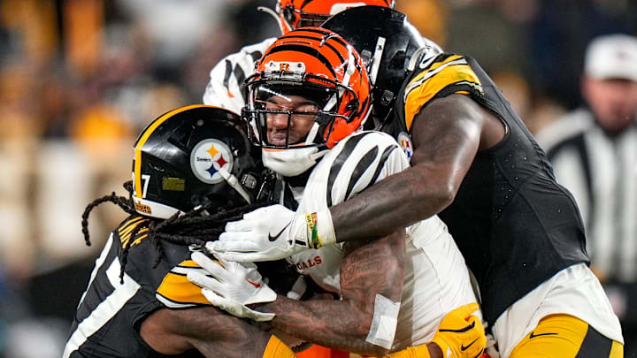 Cincinnati Bengals wide receiver Ja'Marr Chase (1) is wrapped up by Pittsburgh Steelers cornerback Cory Trice Jr. (27) on a reception in the fourth quarter of the NFL Week 18 game between the Pittsburgh Steelers and the Cincinnati Bengals at Acrisure Stadium in Pittsburgh on Saturday, Jan. 4, 2025. The Bengals won 19-17 to finish the regular season at 9-8.