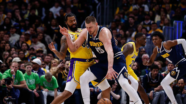 Mar 14, 2025; Denver, Colorado, USA; Denver Nuggets center Nikola Jokic (15) controls the ball as Los Angeles Lakers forward Markieff Morris (88) guards in the third quarter at Ball Arena. Mandatory Credit: Isaiah J. Downing-Imagn Images