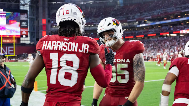 Jan 5, 2025; Glendale, Arizona, USA; Arizona Cardinals wide receiver Marvin Harrison Jr. (18) celebrates a touchdown with tight end Trey McBride (85) against the San Francisco 49ers in the second half at State Farm Stadium. Mandatory Credit: Mark J. Rebilas-Imagn Images Jan 5, 2025; Glendale, Arizona, USA; Arizona Cardinals wide receiver Marvin Harrison Jr. (18) celebrates a touchdown with tight end Trey McBride (85) against the San Francisco 49ers in the second half at State Farm Stadium. Mandatory Credit: Mark J. Rebilas-Imagn Images