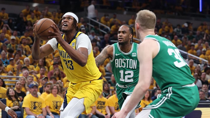 May 25, 2024; Indianapolis, Indiana, USA; Indiana Pacers center Myles Turner (33) dunks against Boston Celtics forward Oshae Brissett (12) and forward Sam Hauser (30) during the second quarter of game three of the eastern conference finals in the 2024 NBA playoffs at Gainbridge Fieldhouse. Mandatory Credit: Trevor Ruszkowski-USA TODAY Sports