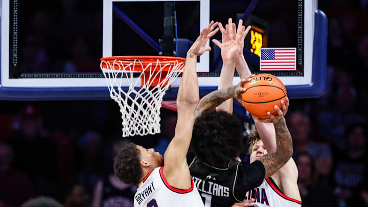 Jan 11, 2025; Tucson, Arizona, USA; UCF Knights guard Mikey Williams (1) attempts a basket against Arizona Wildcats forward Carter Bryant (9) and Arizona Wildcats forward Henri Veesaar (13) during the second half of the game at McKale Center. Mandatory Credit: Aryanna Frank-Imagn Images