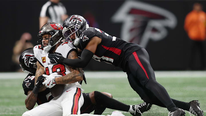 Sep 7, 2025; Atlanta, Georgia, USA; Atlanta Falcons cornerback A.J. Terrell Jr. (24) and safety Xavier Watts (31) tackle Tampa Bay Buccaneers wide receiver Mike Evans (13)f during the first quarter at Mercedes-Benz Stadium. Mandatory Credit: Brett Davis-Imagn Images