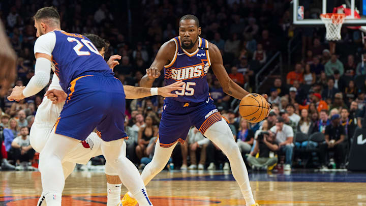 Nov 2, 2024; Phoenix, Arizona, USA;  Phoenix Suns forward Kevin Durant (35) dribbles through the screen set by  center Jusuf Nurkić (20) in the first half during a game against the Portland Trail Blazers at Footprint Center. Mandatory Credit: Allan Henry-Imagn Images
