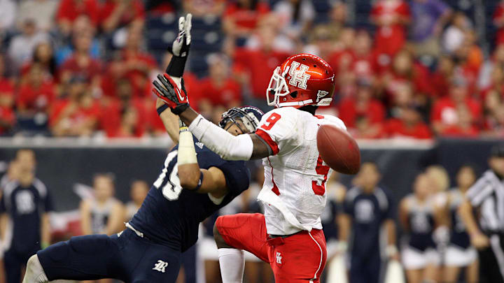 September 29, 2012; Houston, TX, USA; Rice Owls cornerback Phillip Gaines (15) defends against a pass intended for Houston Cougars wide receiver Dewayne Peace (9) in the fourth quarter at Reliant Stadium. Mandatory Credit: Troy Taormina-Imagn Images