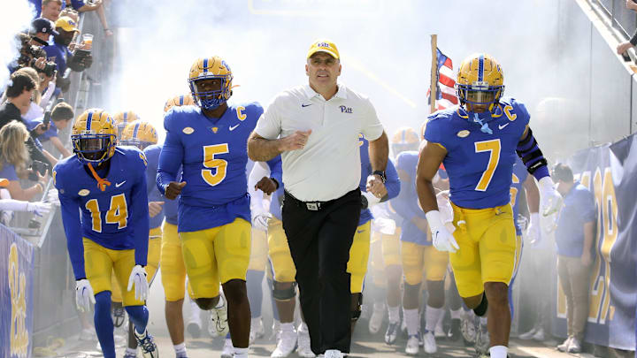 Sep 24, 2022; Pittsburgh, Pennsylvania, USA;  Pittsburgh Panthers defensive back Marquis Williams (14) and defensive lineman Deslin Alexandre (5) and Panthers head coach Pat Narduzzi and linebacker SirVocea Dennis (7) lead the team onto the field to play the Rhode Island Rams at Acrisure Stadium. Mandatory Credit: Charles LeClaire-Imagn Images