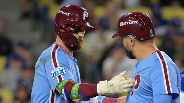 Oct 8, 2025; Los Angeles, California, USA; Philadelphia Phillies designated hitter Kyle Schwarber (12) is congratulated by first baseman Bryce Harper (3) after hitting a solo home run in the fourth inning against the Los Angeles Dodgers of game three of the NLDS during the 2025 MLB playoffs at Dodger Stadium. 