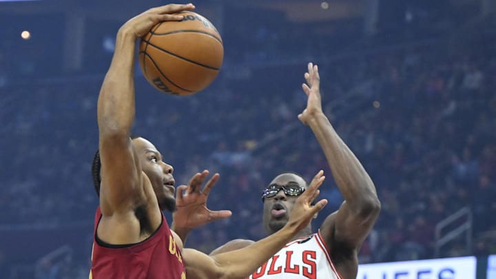 Apr 8, 2025; Cleveland, Ohio, USA; Cleveland Cavaliers forward Isaac Okoro (35) drives to the basket beside Chicago Bulls forward Jalen Smith (7) in the first quarter at Rocket Arena. Mandatory Credit: David Richard-Imagn Images