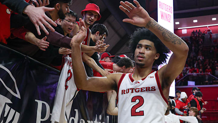 Mar 9, 2025; Piscataway, New Jersey, USA; Rutgers Scarlet Knights guard Dylan Harper (2) slap hands with fans after the game against the Minnesota Golden Gophers at Jersey Mike's Arena. Mandatory Credit: Vincent Carchietta-Imagn Images