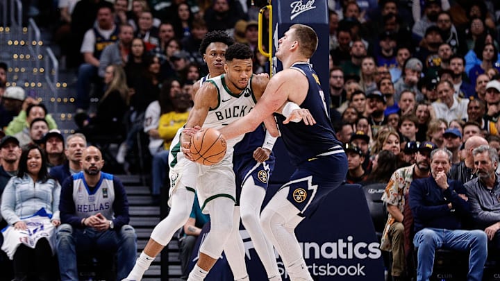 Jan 29, 2024; Denver, Colorado, USA; Milwaukee Bucks forward Giannis Antetokounmpo (34) controls the ball under pressure from Denver Nuggets center Nikola Jokic (15) and forward Peyton Watson (8) in the fourth quarter at Ball Arena. Mandatory Credit: Isaiah J. Downing-Imagn Images