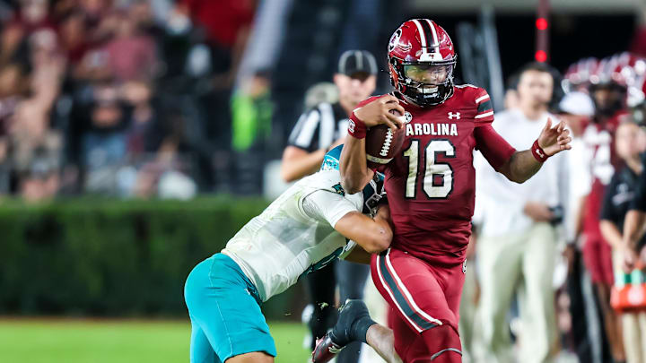 Nov 22, 2025; Columbia, South Carolina, USA; South Carolina Gamecocks quarterback Lanorris Sellers (16) is knocked out of bounds by Coastal Carolina Chanticleers cornerback Myles Mooyoung (8) in the second half at Williams-Brice Stadium. Mandatory Credit: Jeff Blake-Imagn Images