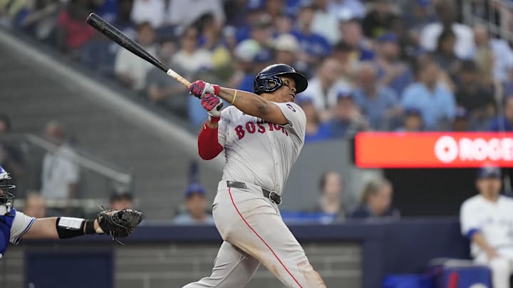 Jun 18, 2024; Toronto, Ontario, CAN; Boston Red Sox third baseman Rafael Devers (11) hits a double against the Toronto Blue Jays during the sixth inning at Rogers Centre.
