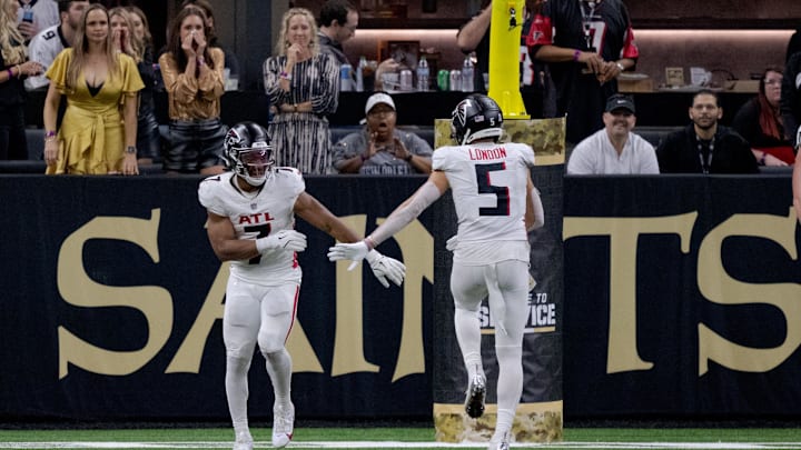 Nov 10, 2024; New Orleans, Louisiana, USA; Atlanta Falcons running back Bijan Robinson (7) celebrates a touchdown with Atlanta Falcons wide receiver Drake London (5) during the second half against the New Orleans Saints at Caesars Superdome. Mandatory Credit: Matthew Hinton-Imagn Images