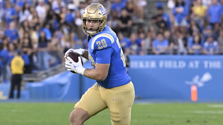 Oct 12, 2024; Pasadena, California, USA; UCLA Bruins tight end Jack Pedersen (28) catches a pass against the Minnesota Golden Gophers during the first quarter at Rose Bowl. Mandatory Credit: Robert Hanashiro-Imagn Images