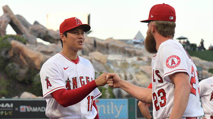 Angels starting pitcher Shohei Ohtani (17) gets a fist bump from relief pitcher Archie Bradley (23) before the game against the Houston Astros at Angel Stadium on April 7, 2022.